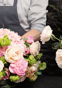A lush, lively outdoor plant climbs a stone wall