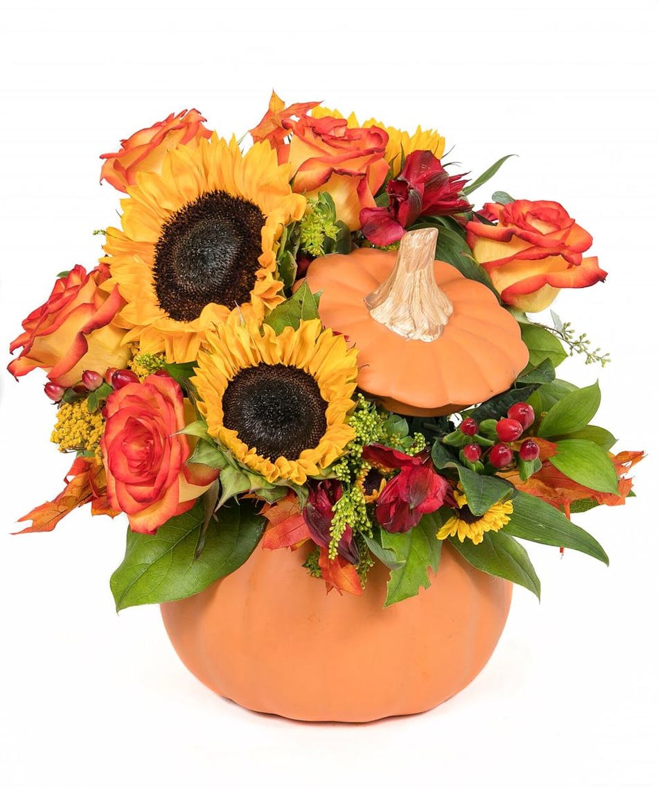 Rustic autumn flowers are stunning in a ceramic pumpkin that looks like it just came from the patch.