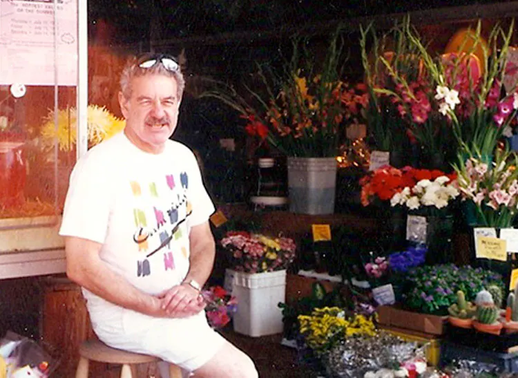 Myron Levine watches foot traffic from his stool just outside the showroom's front door