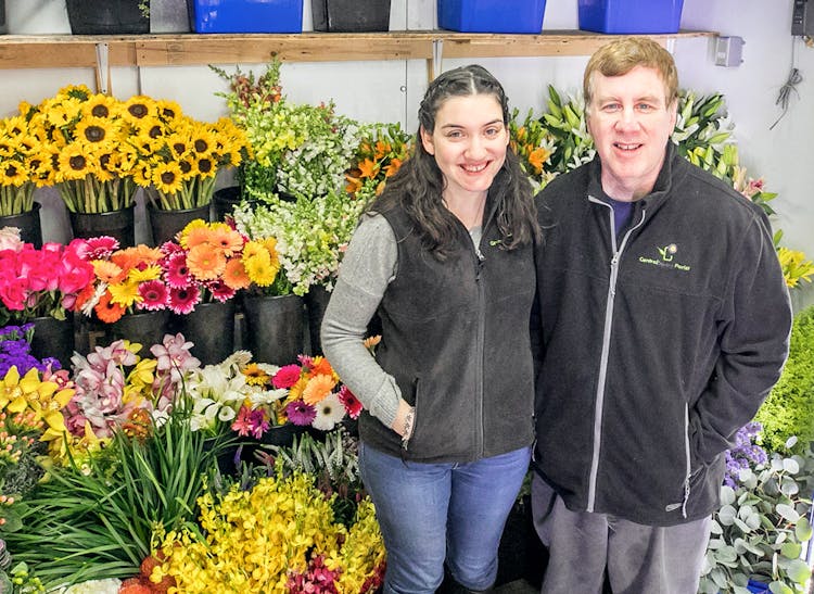 David and Jackie Levine, store owners, pose with several lovely bouquets